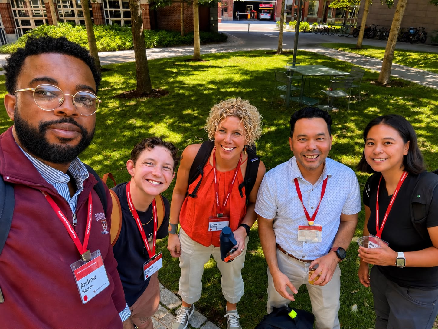 Andrew Herron with fellow HKS students in the Kennedy School courtyard