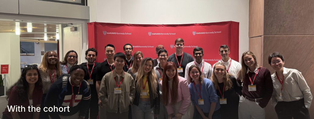Xinyi with the MPA cohort in front of the red Harvard Kennedy School backdrop