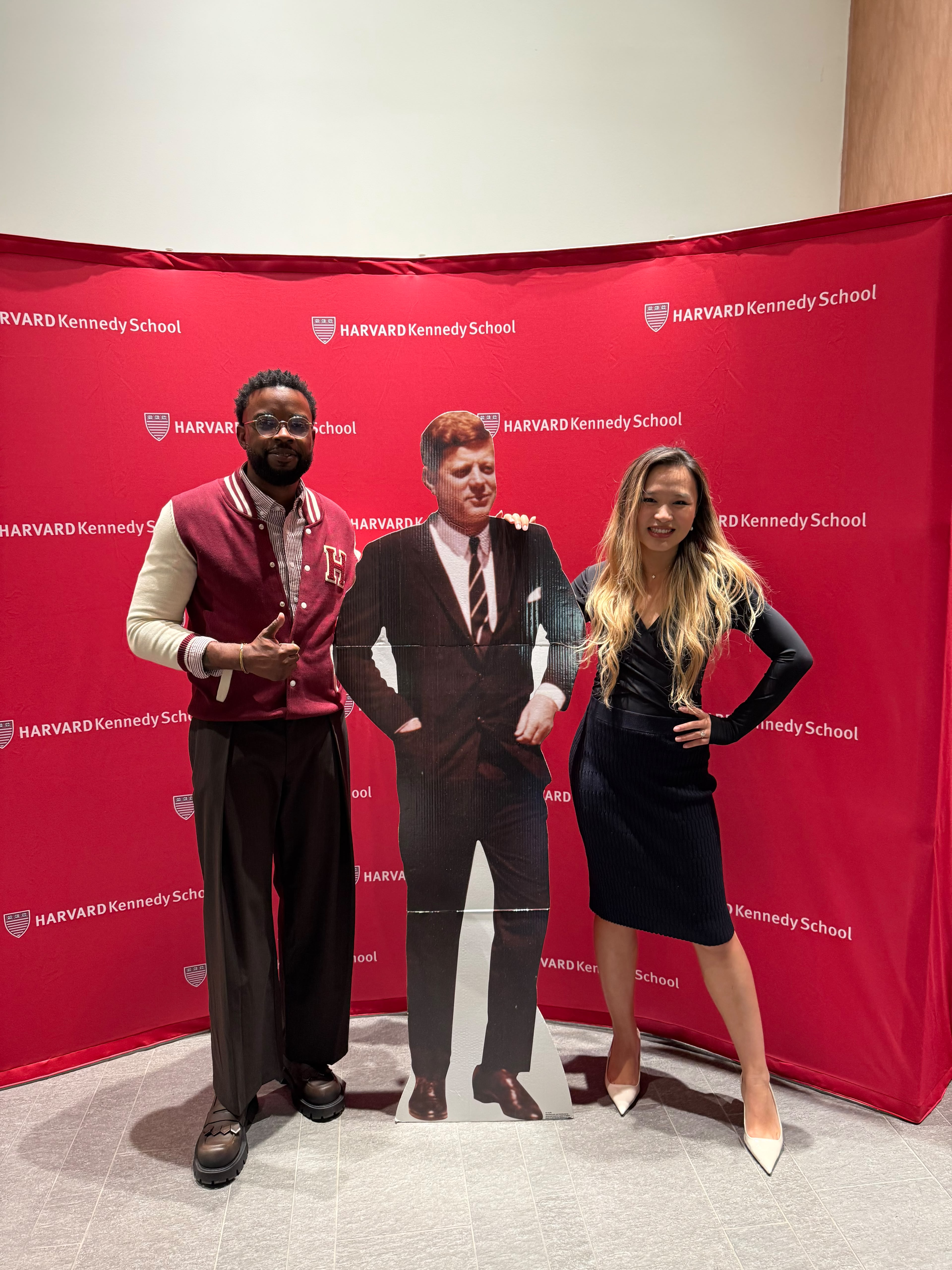 Xinyi and Andrew posing with a JFK cutout at the Harvard Kennedy School backdrop