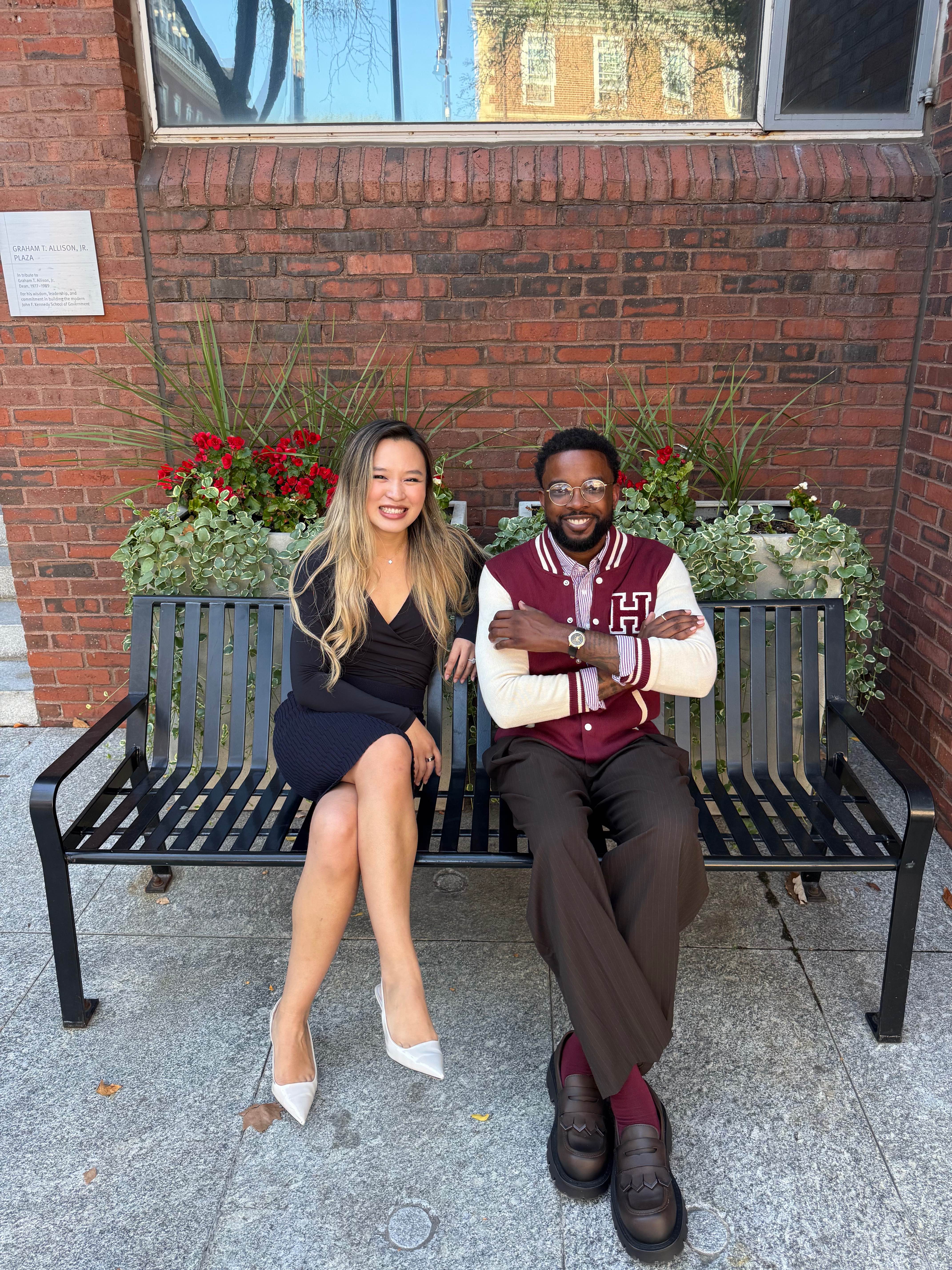 Xinyi and Andrew on a bench at Graham T. Allison Jr. Plaza on the HKS campus
