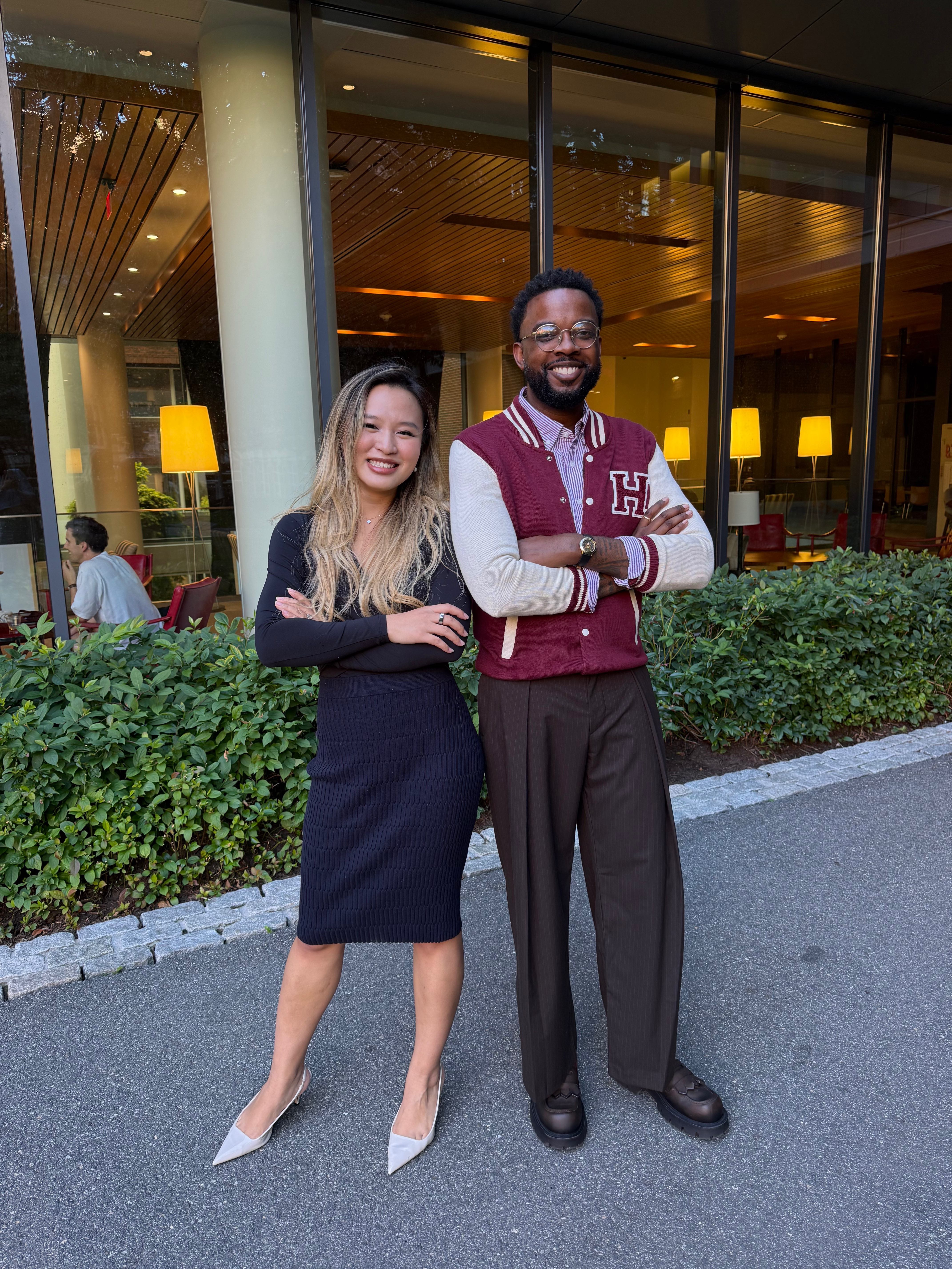 Xinyi and Andrew outside a Harvard Kennedy School building at dusk